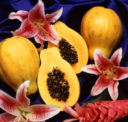 Whole and Half Papayas With Flowers