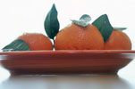 Three Whole Tangerines on a Plate